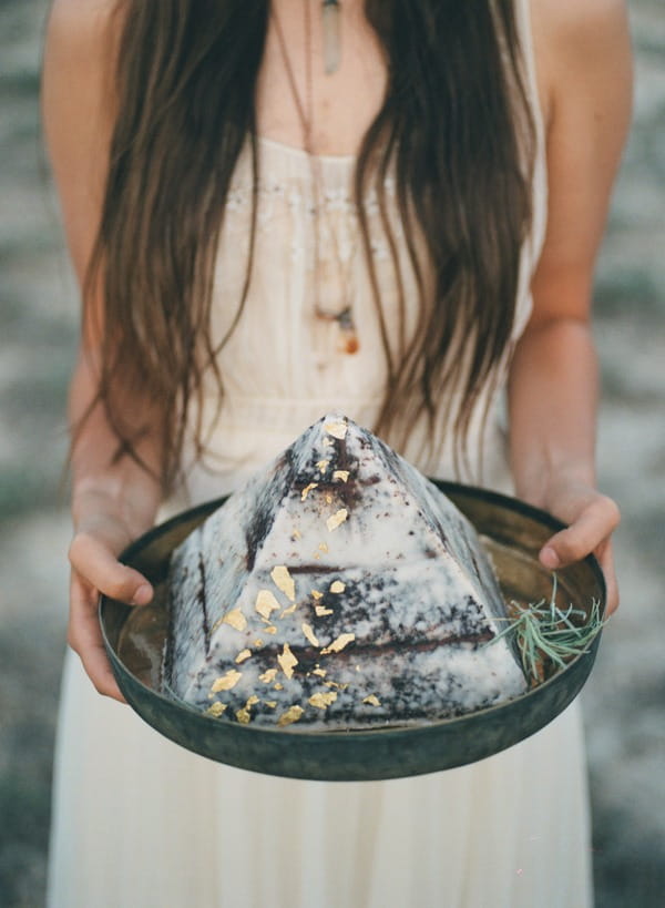 Bride holding pyramid cake on tray