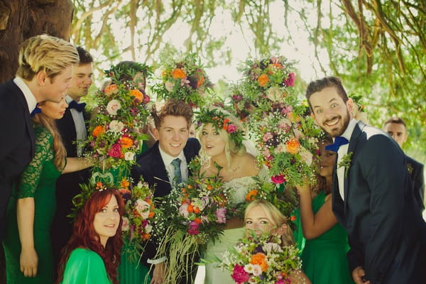 Bridal party posing with flowers