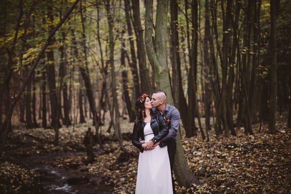 Groom kissing bride from behind