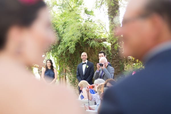 Groom waiting for bride to walk down aisle