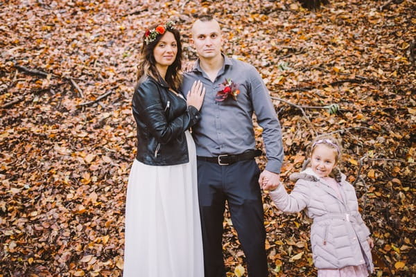 Couple with flower girl in forest