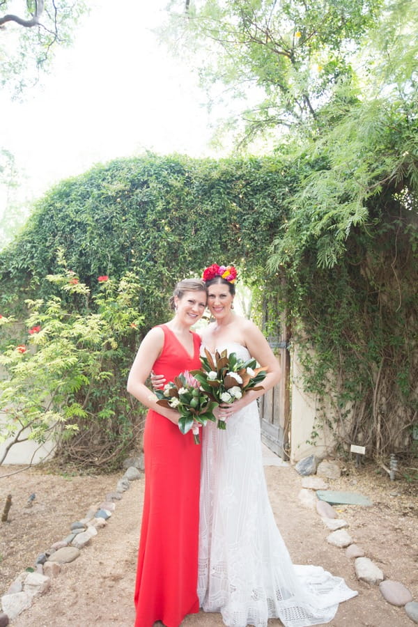 Bride with bridesmaid in red dress