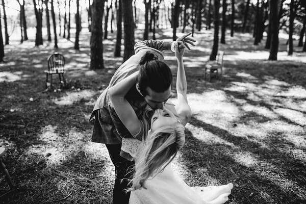 Bride and groom leaning over and kissing