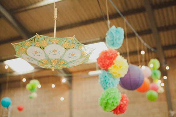 Umbrella and pom pom hanging from ceiling