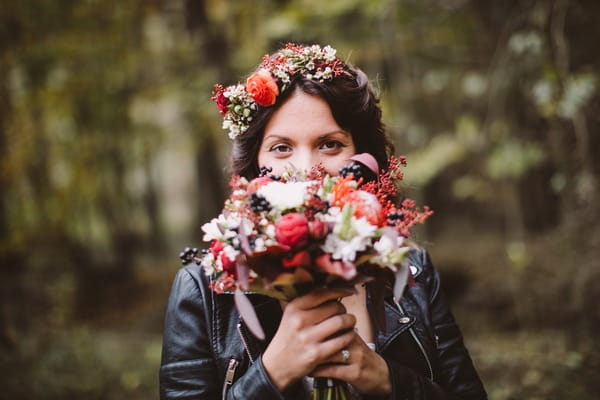 Bride holding bouquet in front of face