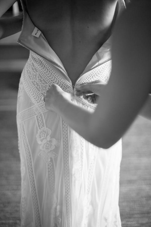 Doing up bride's dress