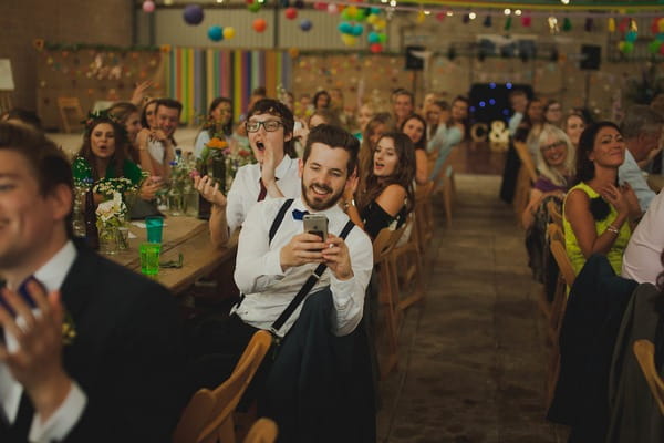 Wedding guest taking picture on phone