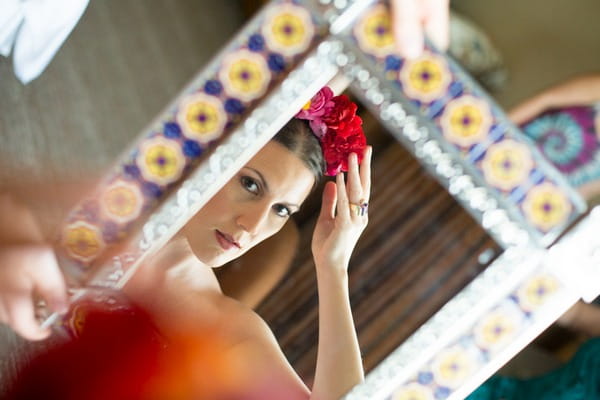 Bride adjusting flower crown in mirror