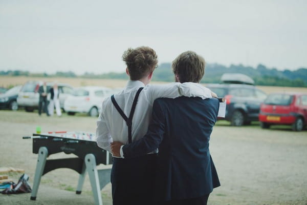 Groom with arms around friend