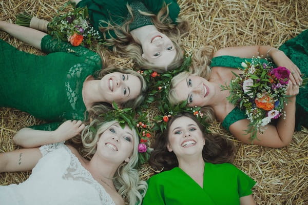 Bride and bridesmaids laying down