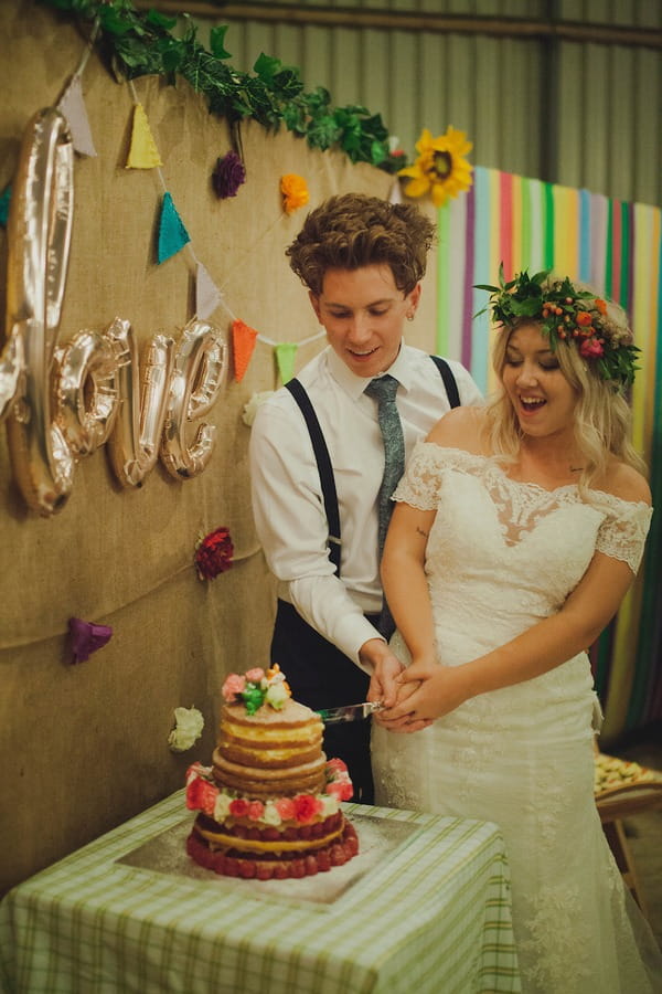 Bride and groom cutting cake