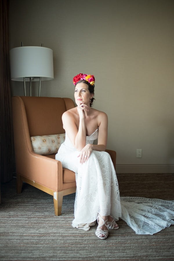 Bride with flower crown sitting in chair
