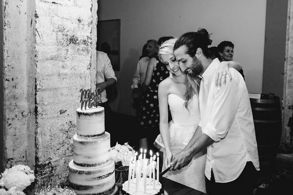 Bride and groom cutting wedding cake