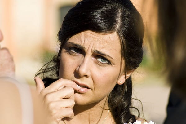Anxious woman biting nails due to nerves
