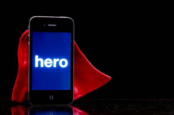 Mobile phone with cape and word hero on