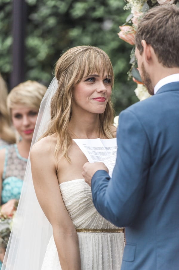 Bride saying personal wedding vows to bride