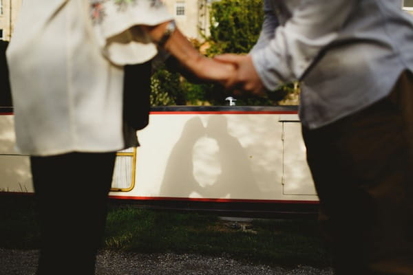 Shadow on side of boat of couple kissing