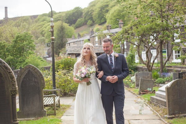 Father walking bride down church path