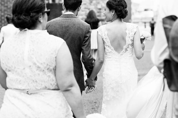 Bride and groom holding hands