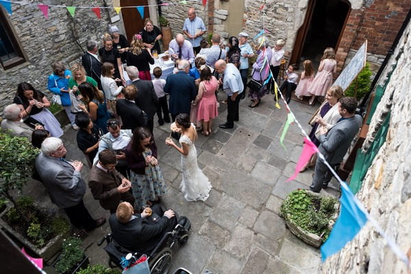 Wedding guests in courtyard at Scaplen's Court