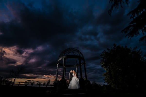 Bride and groom under Swancar Farm gazebo at night - Picture by Kimberley Hill Photography