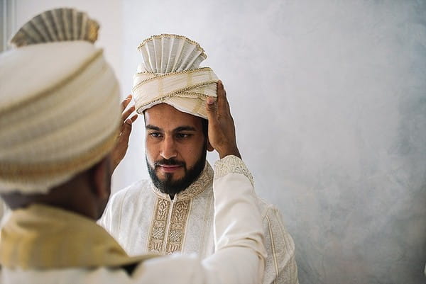 Indian groom having Safa placed on his head - Picture by Jonny Barratt Photography