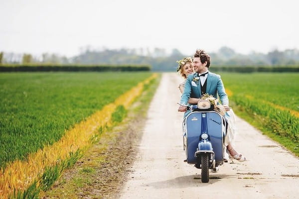 Bride and groom on Vespa scooter