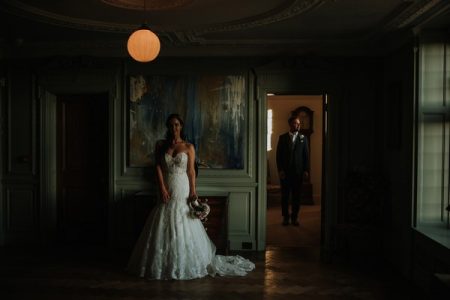 Bride standing in room at Thornton Manor with groom standing in other room seen through open door - Picture by DSB Creative