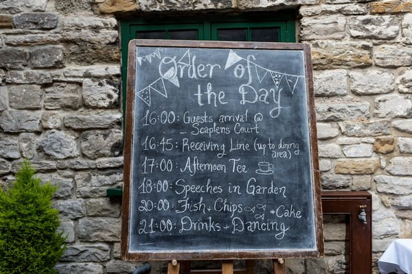 Wedding order of the day written on chalkboard