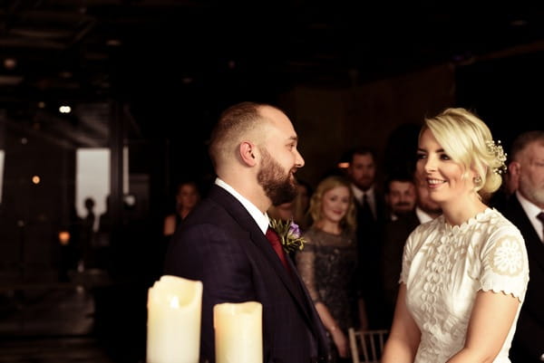 Bride and groom in ceremony at On the 7th wedding