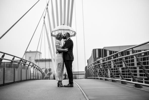 Bride and groom kissing on Manchester Media City Bridge