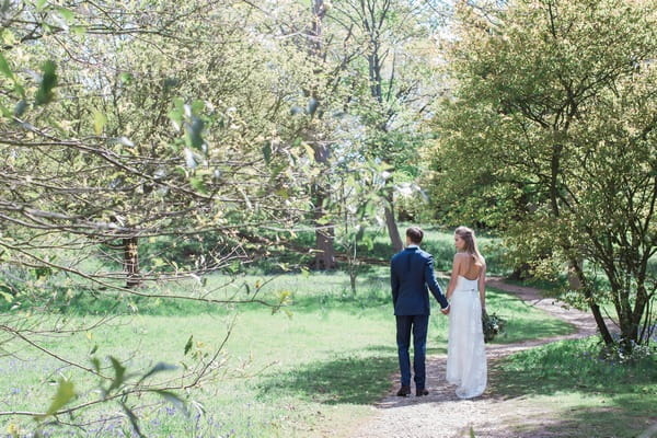 Bride and groom walking in grounds of Pembroke Lodge