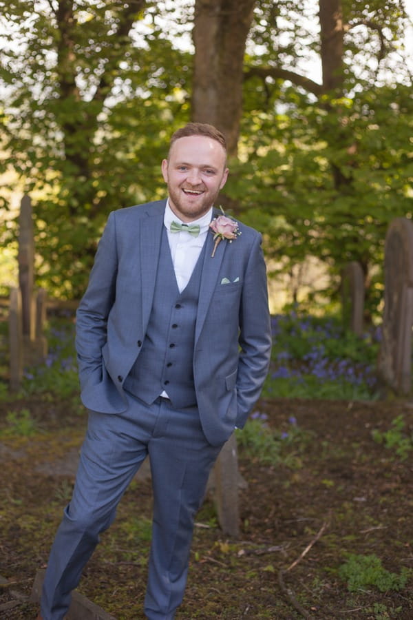 Groom with hands in pockets