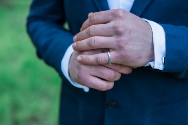 Groom's hands with ring on little finger