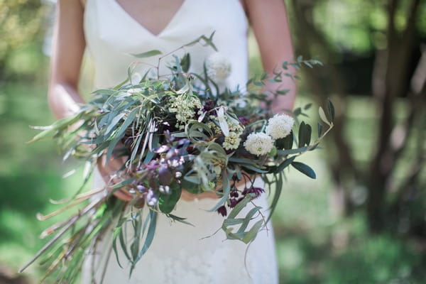 Bride holding wild wedding bouquet