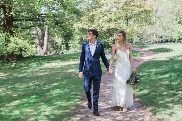 Bride and groom walking holding hands