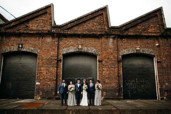 Bridal party in front of large door
