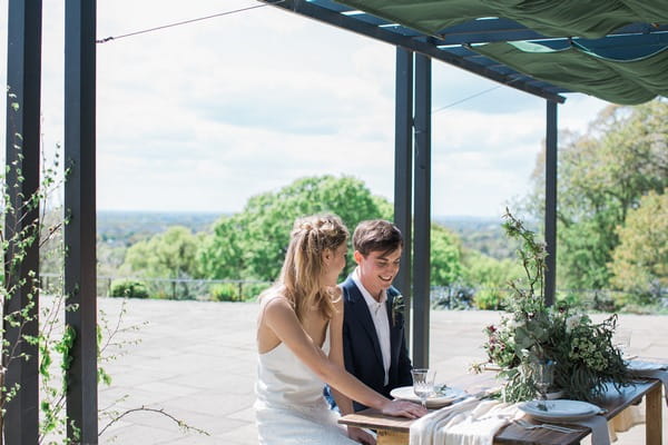 Bride and groom sitting at table