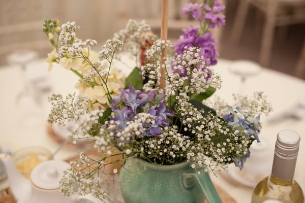 Flowers in jug on wedding table