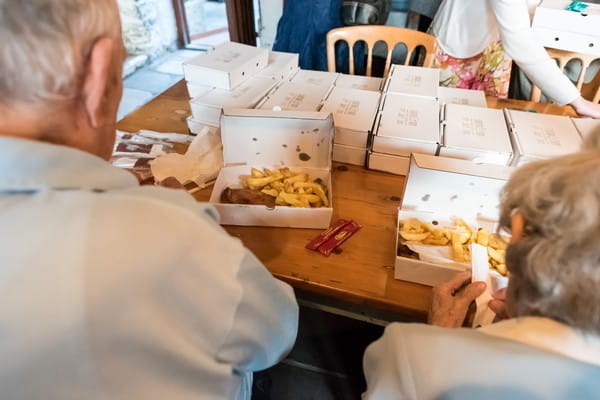 Wedding guests eating fish and chips