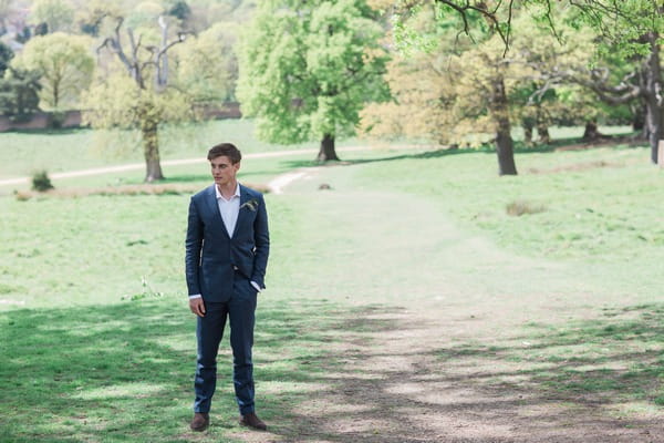 Groom standing with hand in his pocket