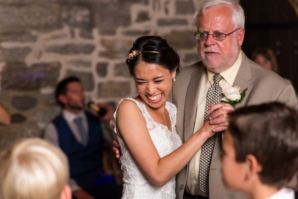 Bride smiling with father