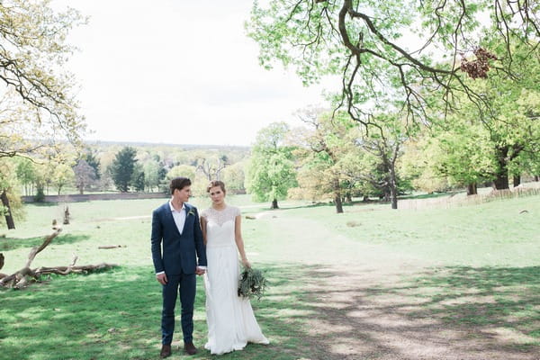 Bride and groom standing in Richmond Park