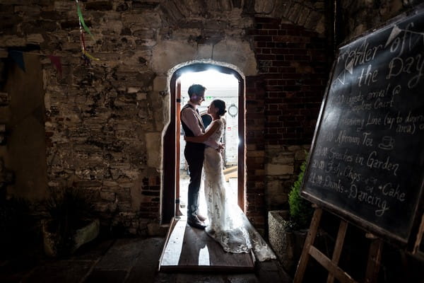 Bride and groom standing in doorway of Scaplen's Court