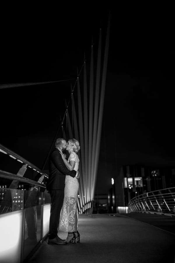 Bride and groom on Manchester Media City Bridge at night