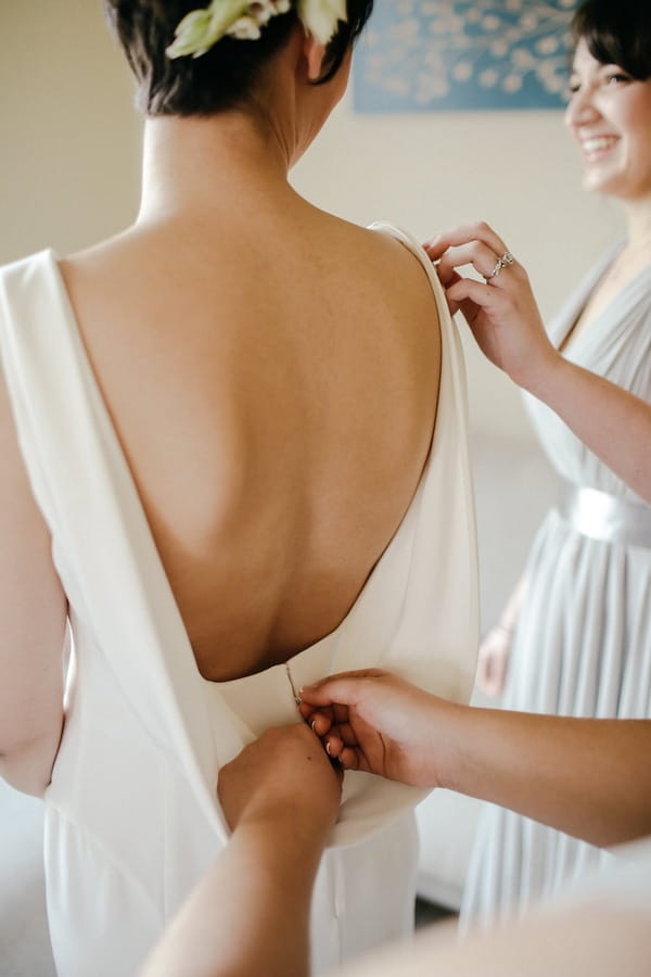 Back of bride's wedding dress being fastened