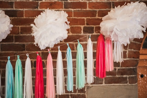 Colourful tassels hanging on wall