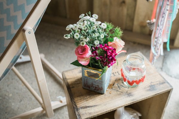 Vintage tin of wedding flowers on table