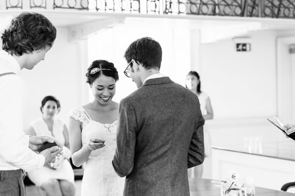 Bride and groom exchanging rings