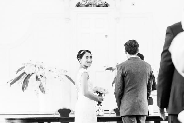 Bride looking over her shoulder during wedding ceremony